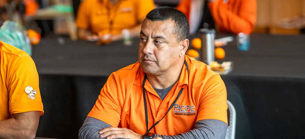 A man wearing an orange shirt with 