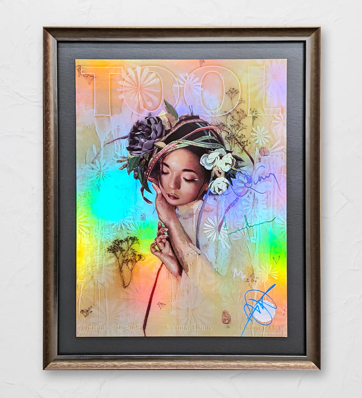 Framed poster with a colorful holographic background, featuring an illustration of a woman with closed eyes, adorned with flowers. Text includes 