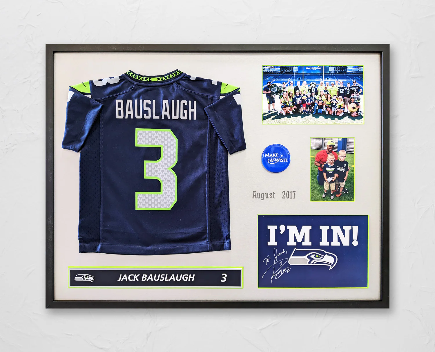 Framed display with a football jersey labeled 