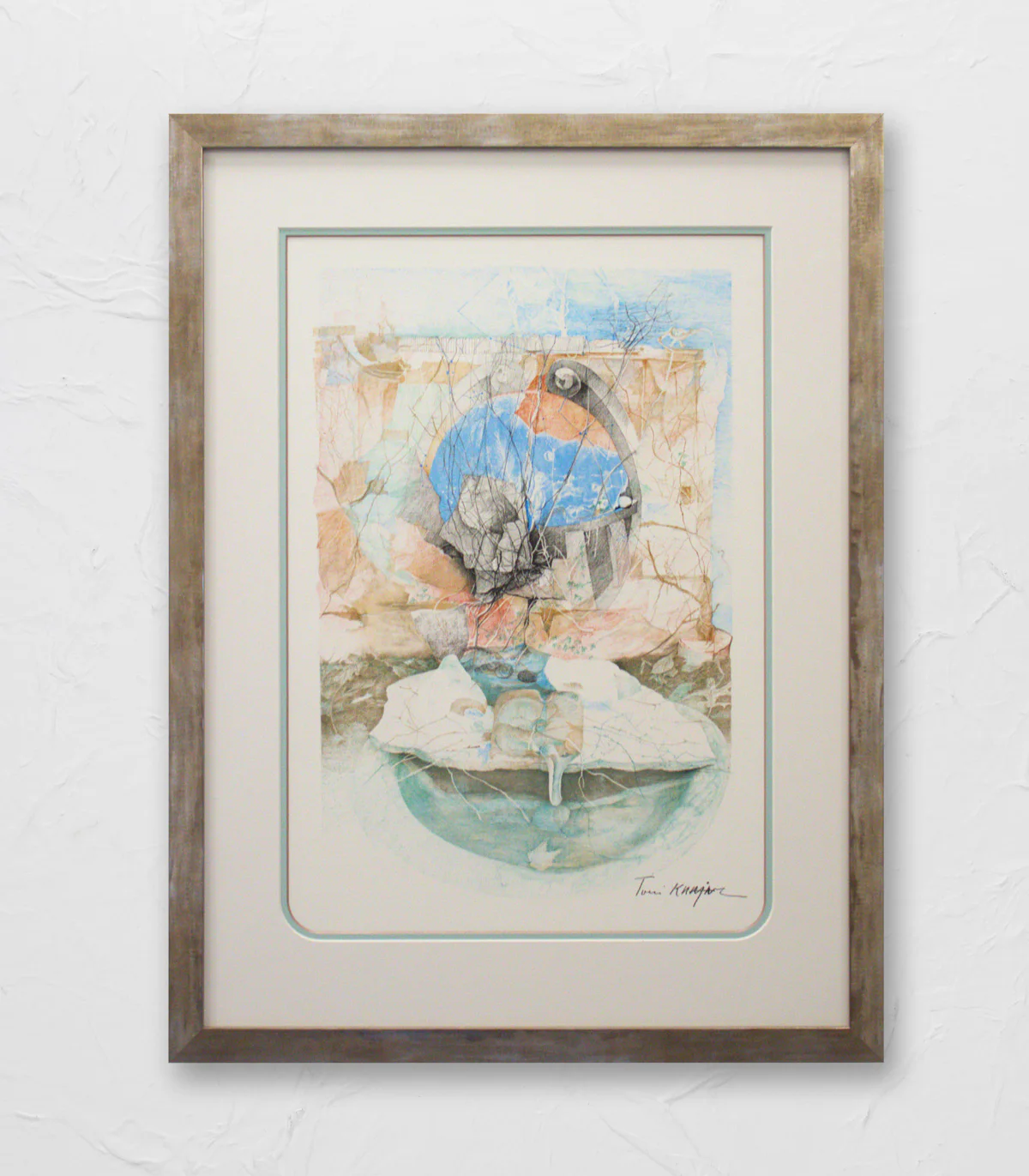 A framed painting shows abstract shapes with a bird perched on top, colored predominantly in blue, gray, and beige tones, hanging on a textured white wall.