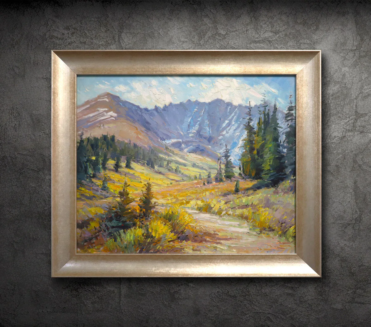 A framed painting of a mountainous landscape with a path running through a field, surrounded by trees and vegetation. The sky is partly cloudy, casting light on the scene.