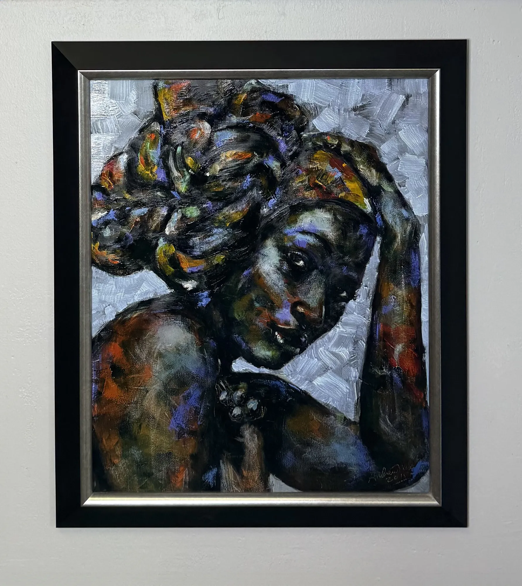 Multicolored abstract painting of a person with a thoughtful expression, head resting on hand. The artwork features swirling hues and textures, framed in a black border.
